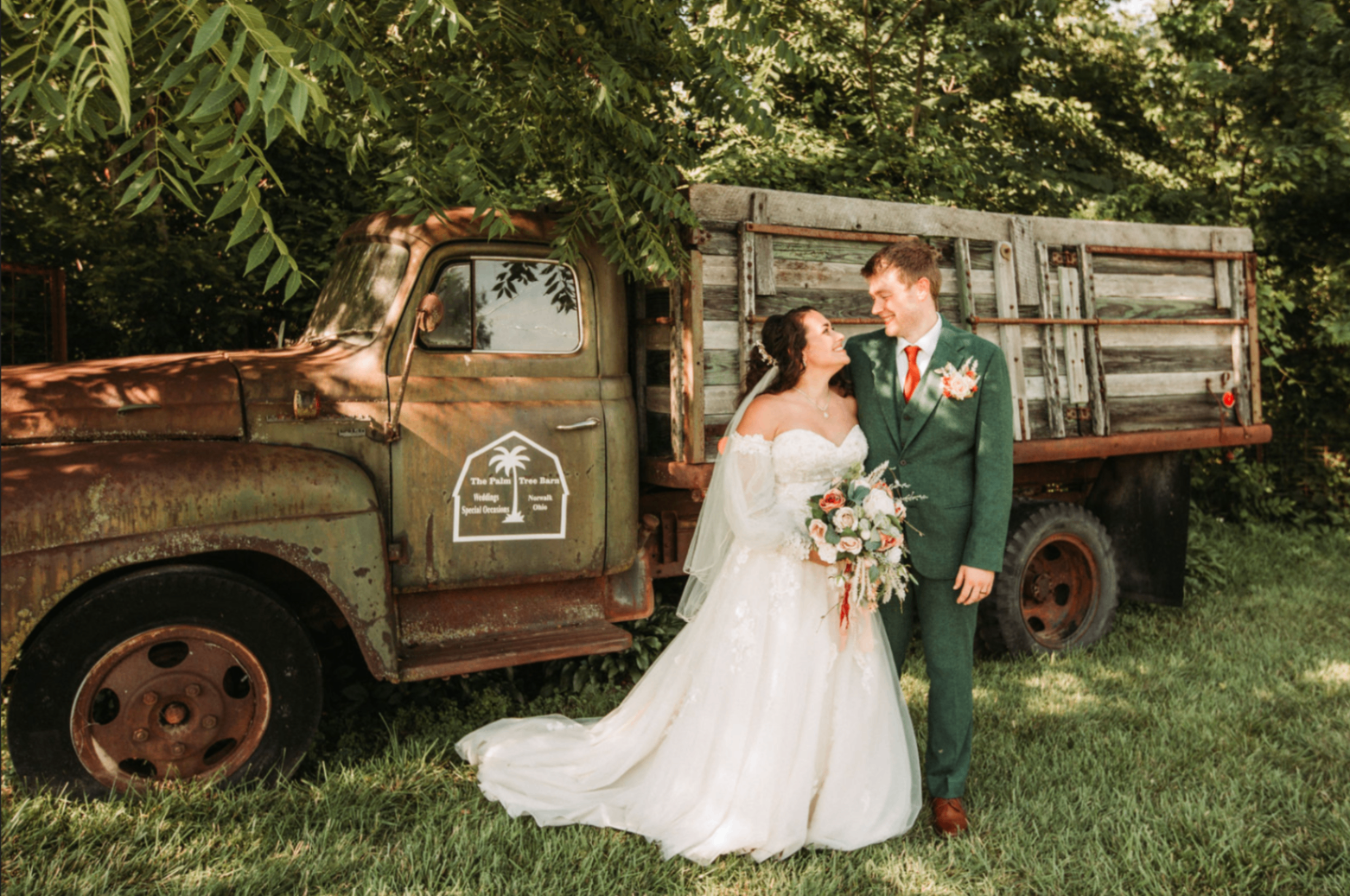 Jessie and Kurtis beside the Palm Tree Barn truck, full-length portrait