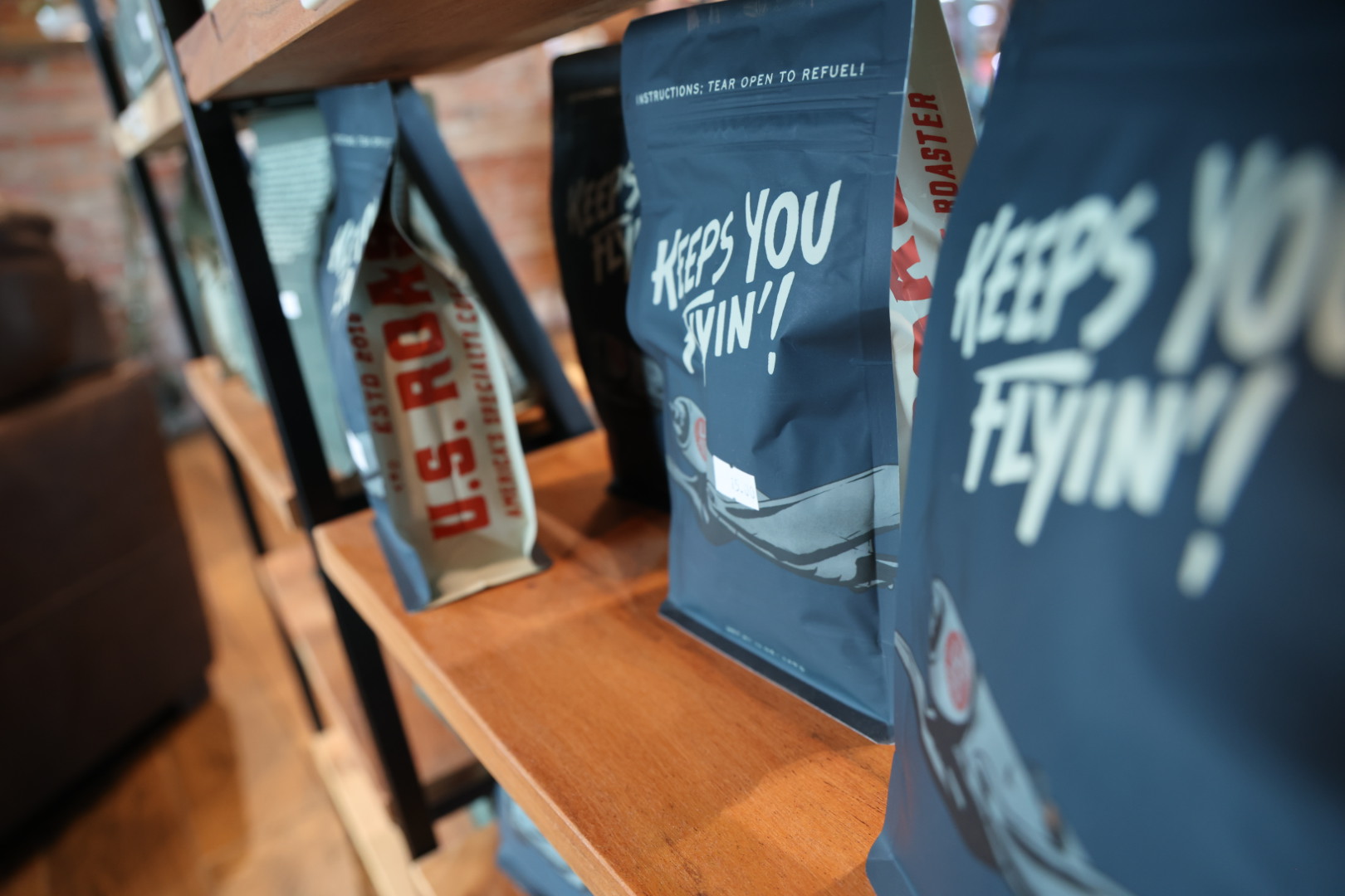 Bags of Keeps You Flyin' coffee lined up on the shelf