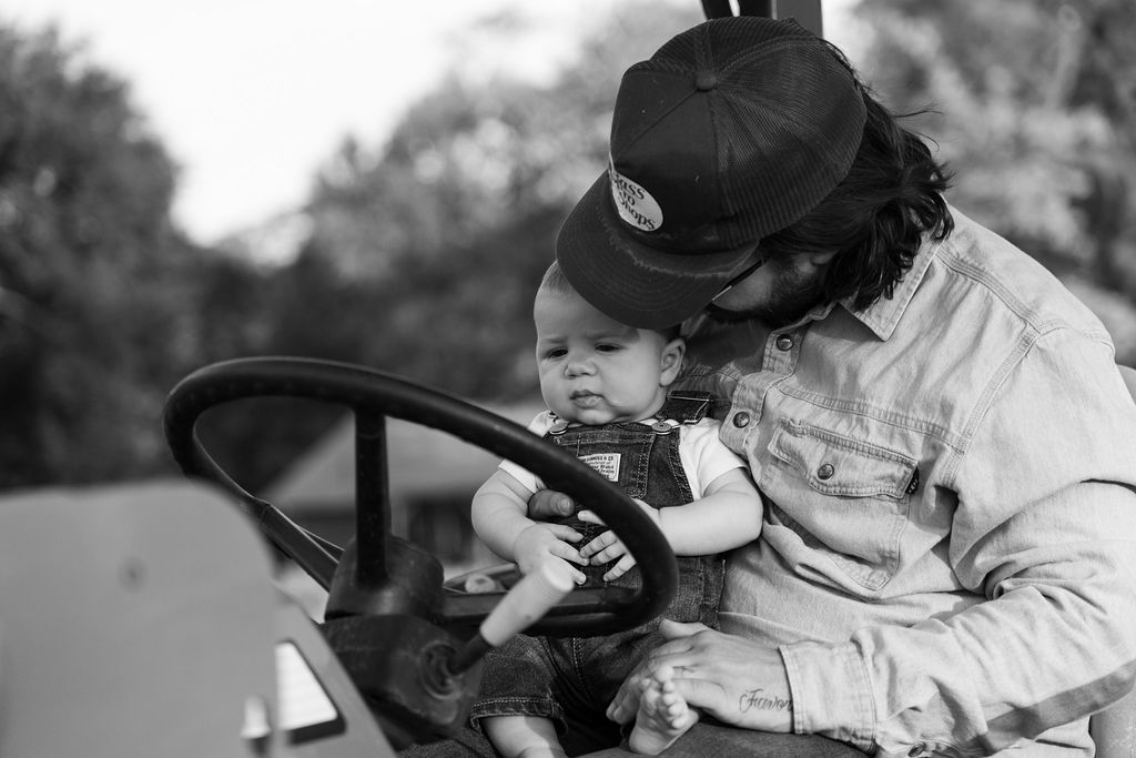 Black and white photograph of a father holding his baby